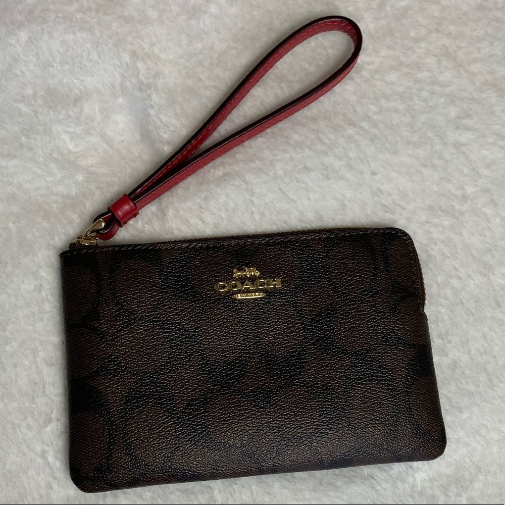 Coach, brown and burgundy signature Coach print wristlet.